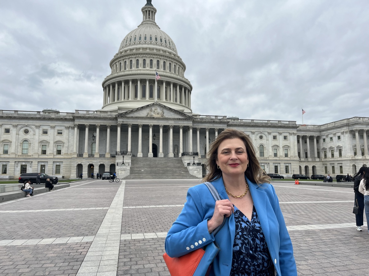 A woman standing outside of The Capitol Building in Washington D.C. 