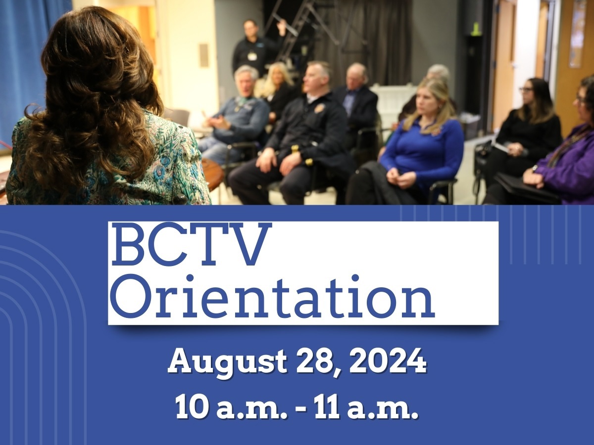 People sitting and watching a presentation for a BCTV orientation. 