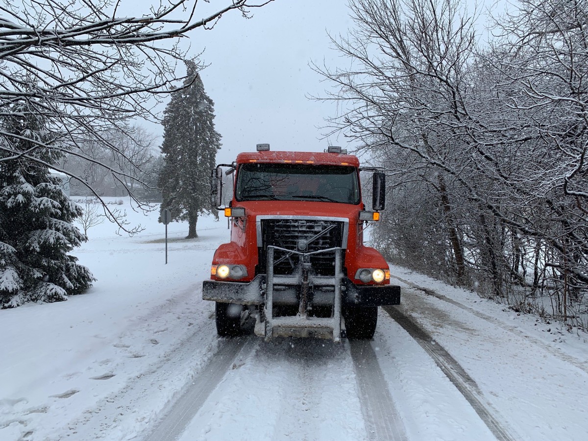 A Bloomfield Township DPW truck driving on a snowy road. 