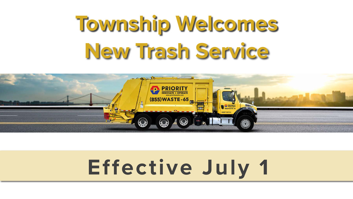 A garbage truck driving down the road. 