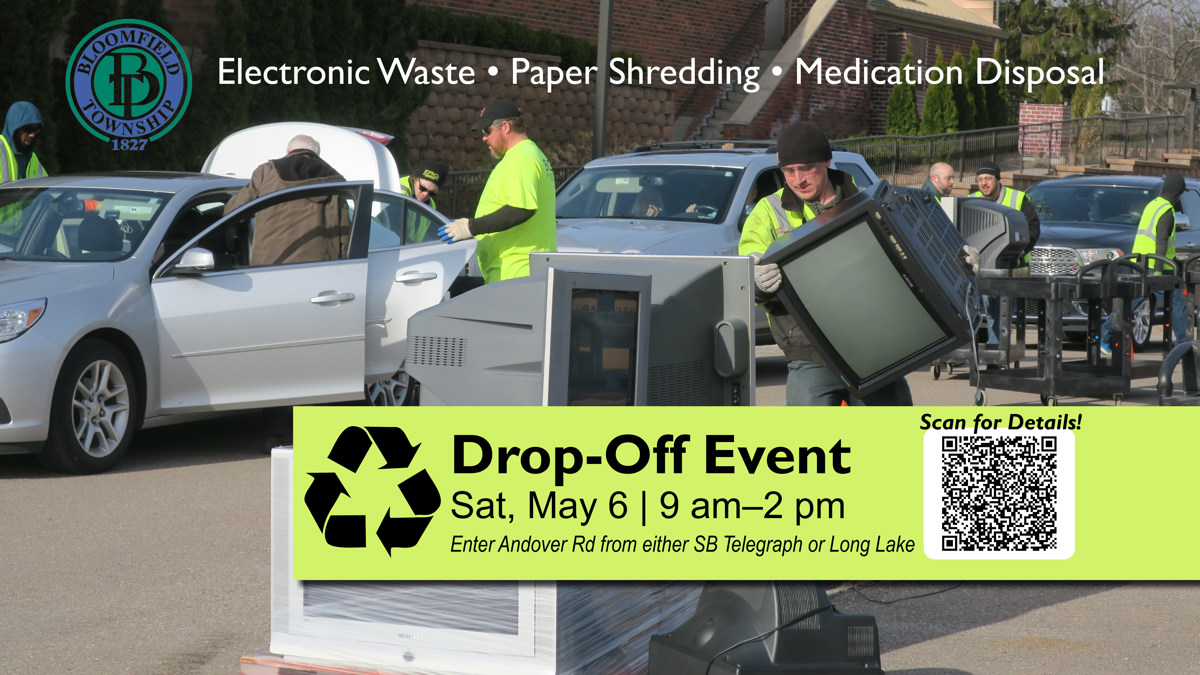 Men taking old electronics out of cars for the drop-off event. 