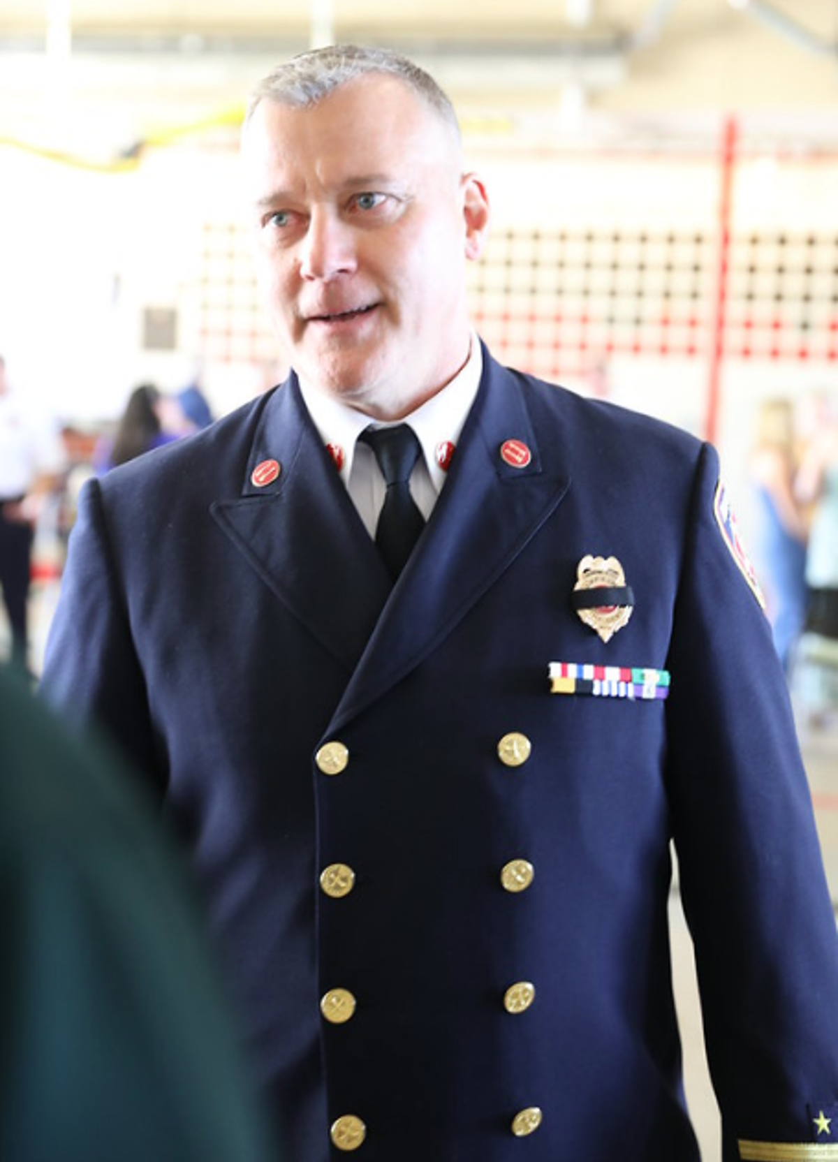 A man in a formal firefighting uniform. 