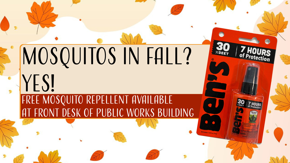 A bottle of Ben's mosquito repellent next to an announcement saying that free mosquito repellent is available at the front desk of the public works building. 