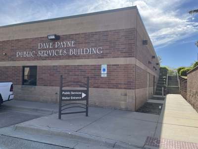 Exterior of Dave Payne Public Services Building showing wayfinding signage to entrance
